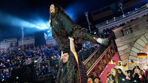 Bei der Abschlusszeremonie der Olympischen Winterspiele 2026 liefen die deutschen Eiskunstläufer Annika Hocke und Robert Kunkel mit einer Hebefigur ein. Team Deutschland holte insgesamt 26 Medaillen.